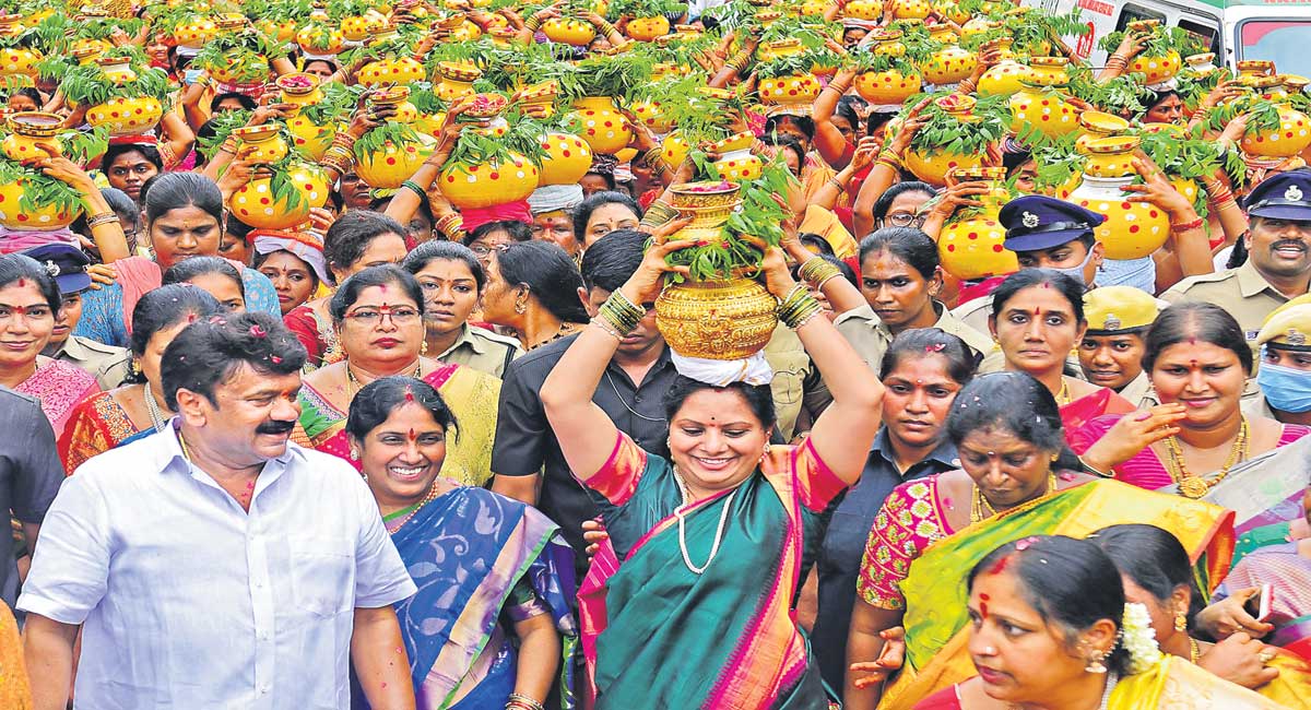 Women in traditional attire celebrating Bathukamma festival in Telangana with floral arrangements and dance